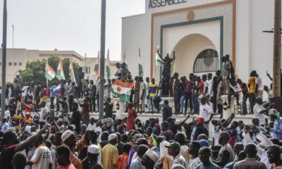 Supporters wave Nigeriens flags as they rally in support of Nigers junta in front of the National