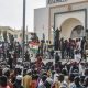 Supporters wave Nigeriens flags as they rally in support of Nigers junta in front of the National