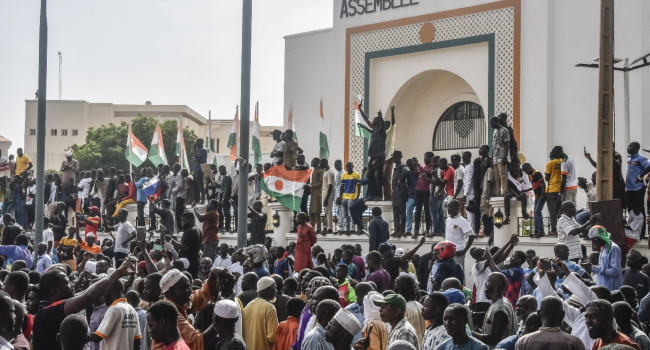 Supporters wave Nigeriens flags as they rally in support of Nigers junta in front of the National